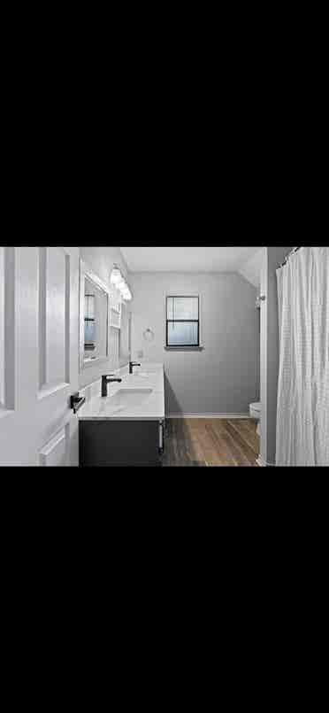 Furnished bedroom with queen bed