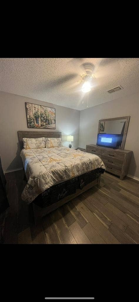 Furnished bedroom with queen bed