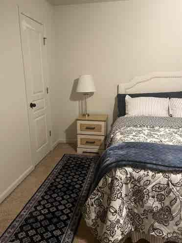 Furnished bedroom with queen bed