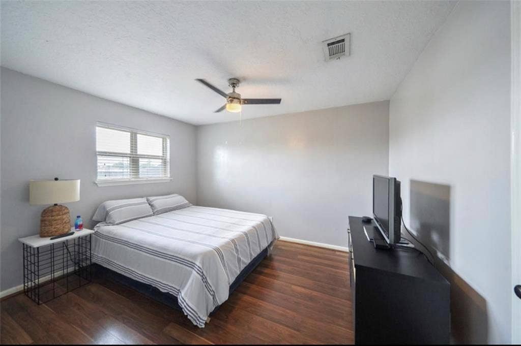 Nice clean bedroom with tv and bed