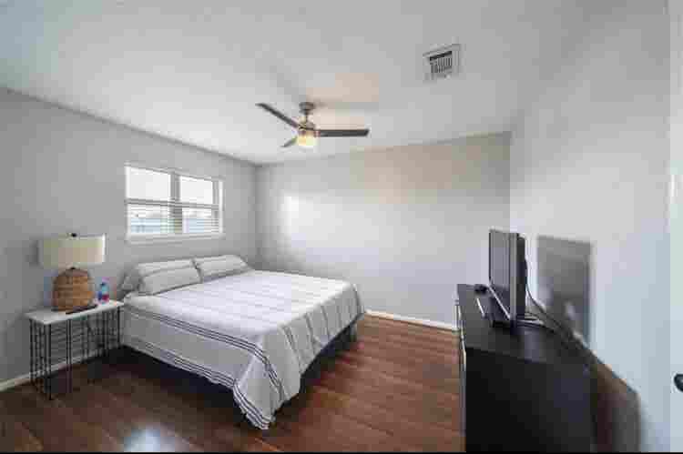 Nice clean bedroom with tv and bed