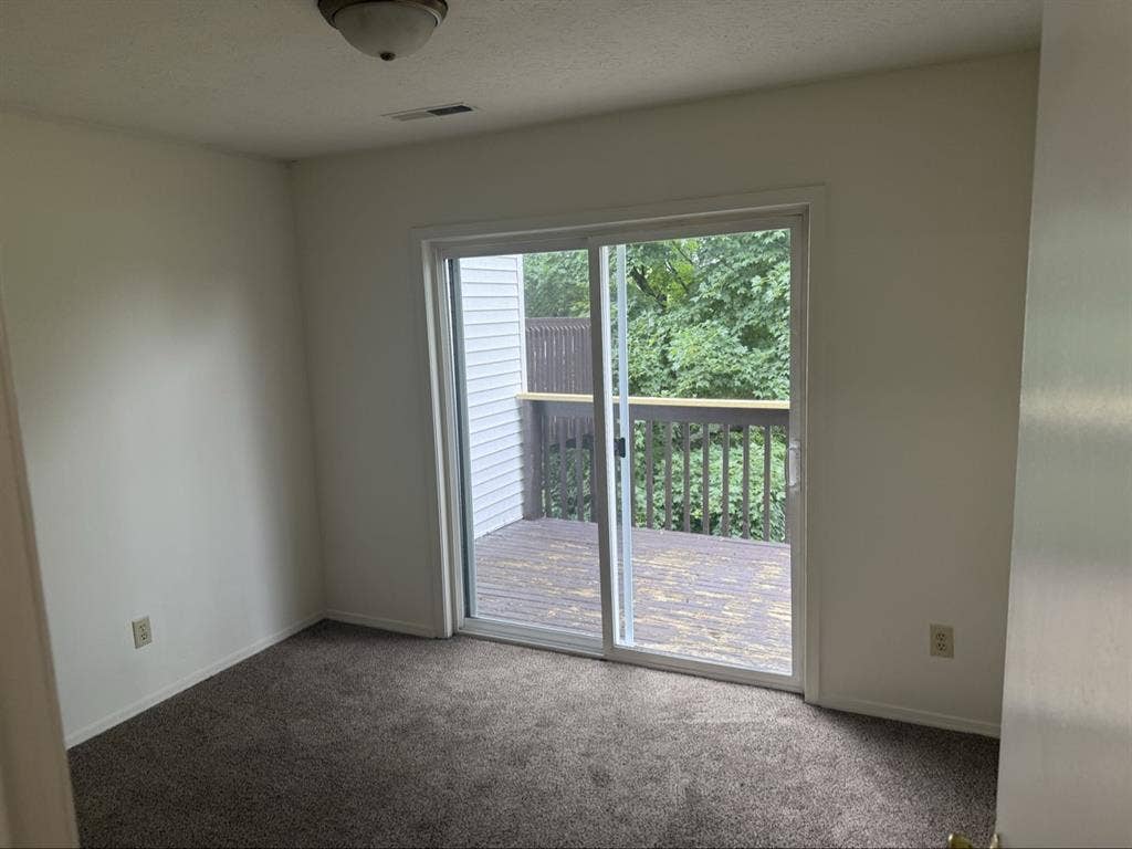 Unfurnished bedroom with balcony