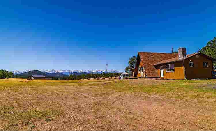 Rural home between forested hills