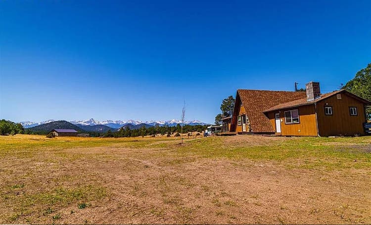 Rural home between forested hills