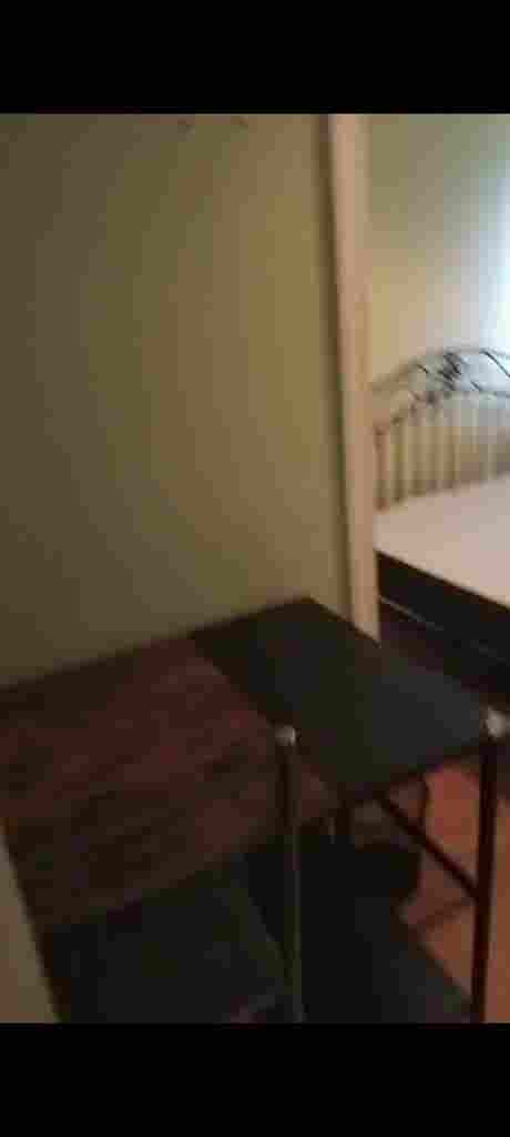 Room with double bed and fridge