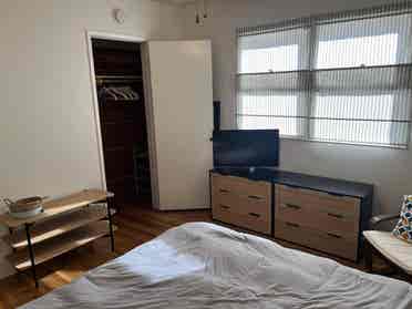 Bedroom open in cozy, artsy home