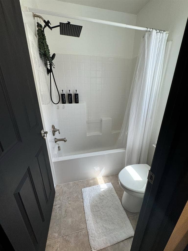Bedroom and full bathroom with tub