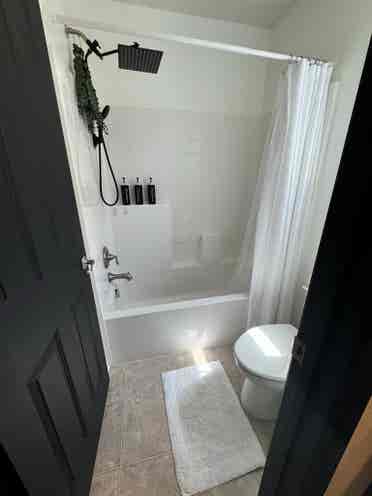 Bedroom and full bathroom with tub