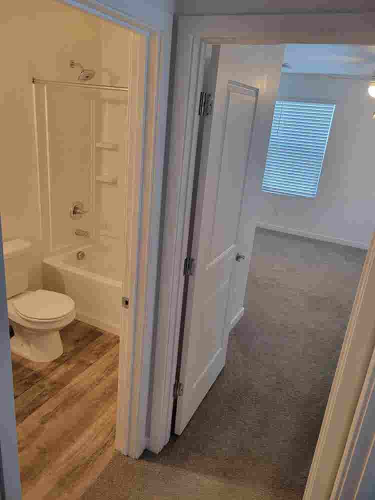 A room, bathroom and a parking spot