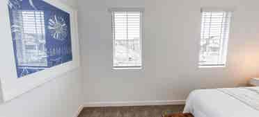 A room, bathroom and a parking spot