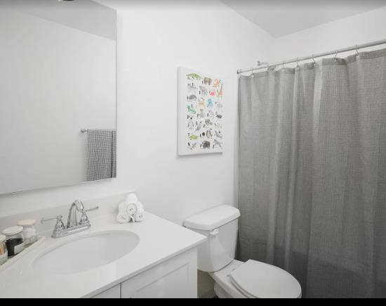 A room, bathroom and a parking spot
