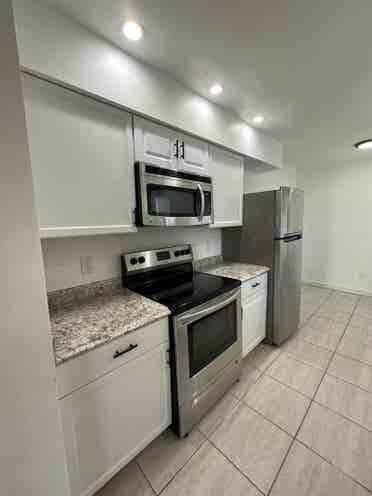 Room with shared bath with utilties