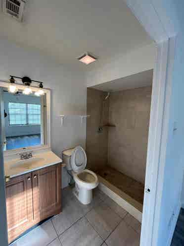 Room with shared bath with utilties