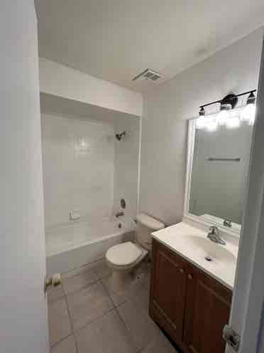 Room with shared bath with utilties