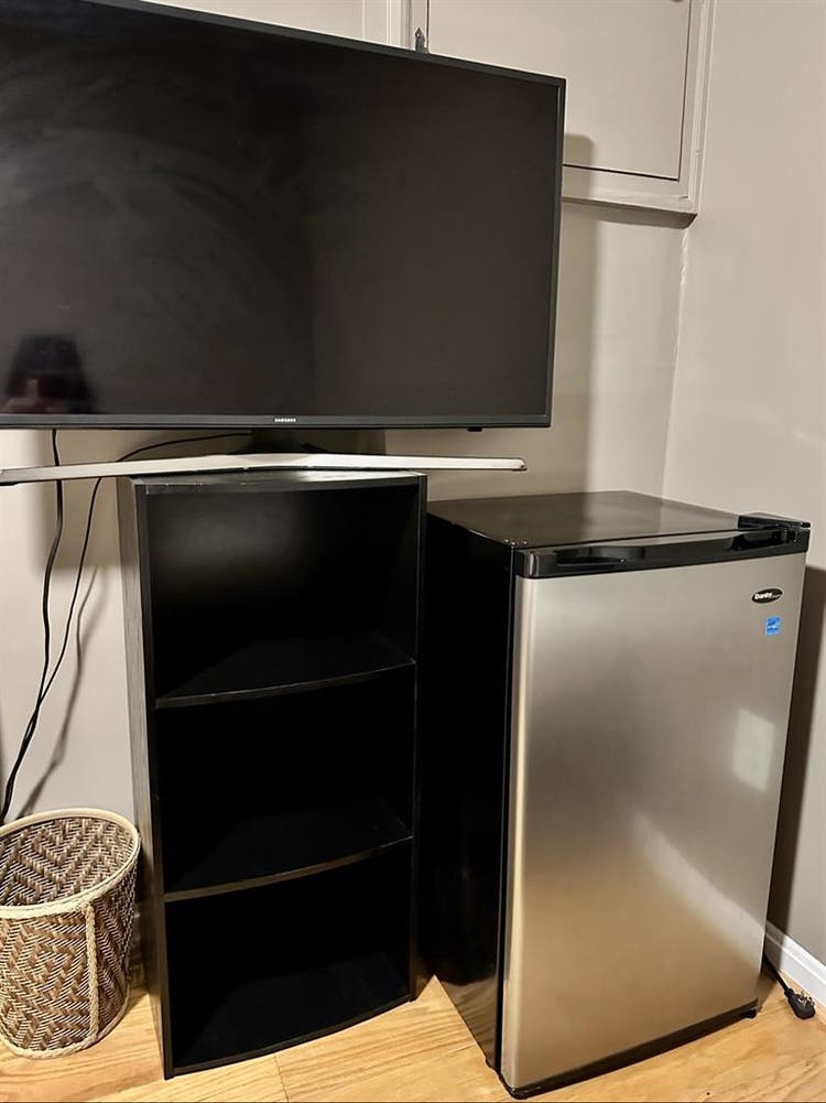 A basement level furnished bedroom.