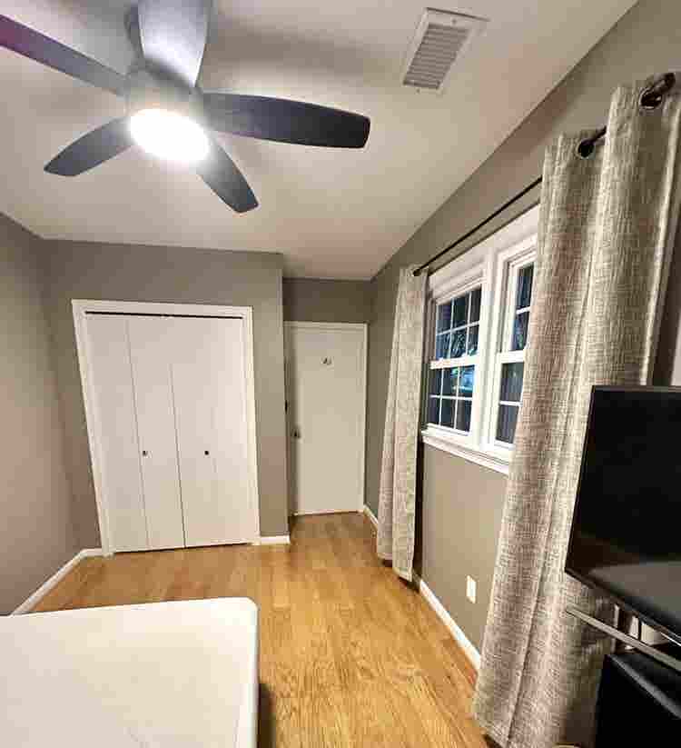 A basement level furnished bedroom.