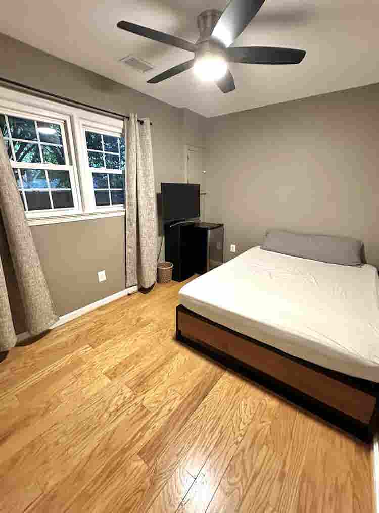 A basement level furnished bedroom.