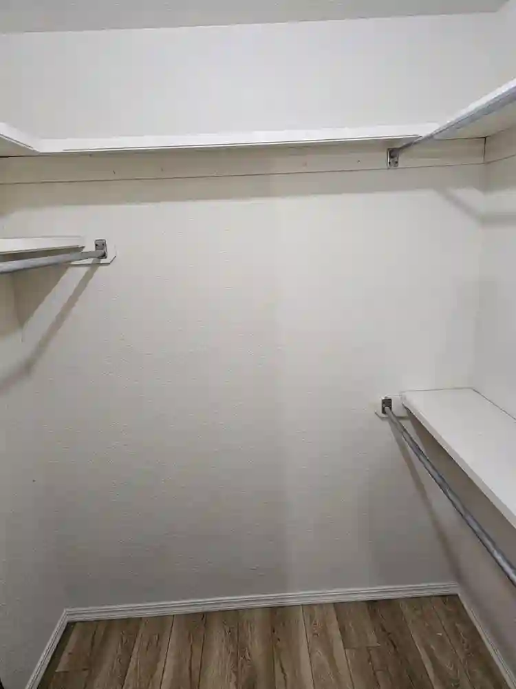 Furnished room with walk in closet.