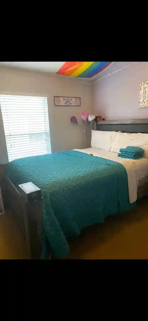 Queen size bed with shared bathroom