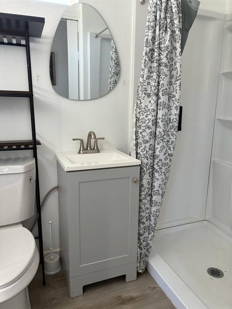 A bedroom with mini-split/fridge