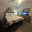 Furnished bedroom with queen bed